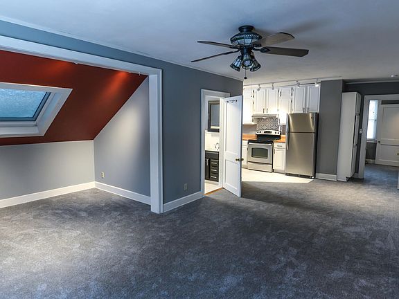 Large open living room plus den with skylight.