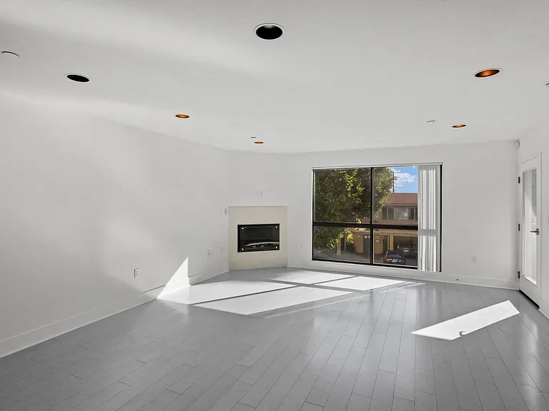 Large-Size Living Room with Electric Fireplace, Patio, and Windows