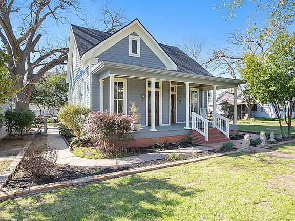 The curb appeal this home offers is just as timeless as the home itself! Brick steps lead to a covered front porch that we are sure you'll spend days relaxing on and visiting with friends & neighbors! A winding sidewalk leads you to shelter under a l
