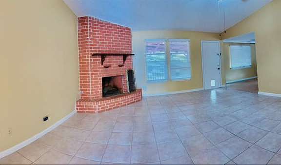 Panoramic view into living room and main hallway leading to bedrooms.