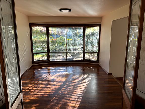 View into dining room from kitchen. Nice bay window looking out to side yard.
