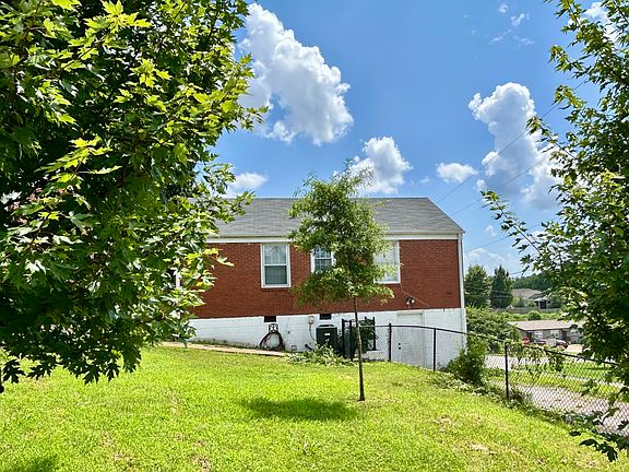 View of fenced back yard and off street parking for 2 cars.