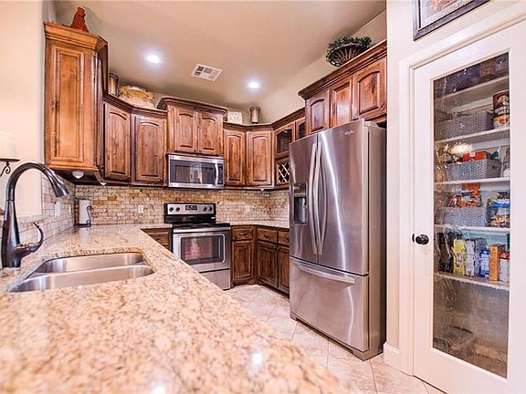Custom built knotty alder cabinets with wine storage and a beautiful pantry door!