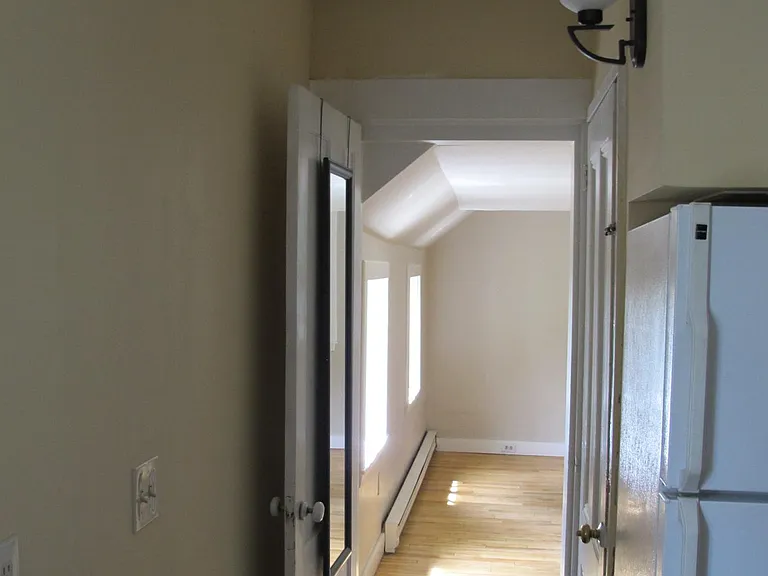 Kitchen to massive bedroom and stairs for basement access.