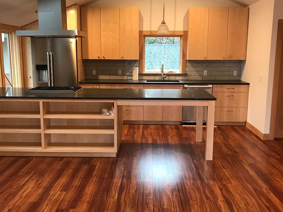View of great room; vaulted ceilings; built-in storage; great flow into kitchen/dining area.