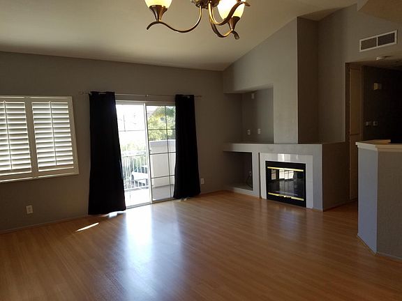 Living Room With Vaulted Ceilings & Sliding Door To Balcony