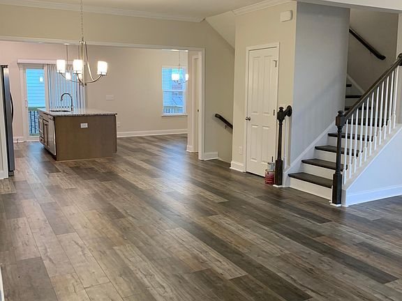 Living room looking into the kitchen & breakfast nook. Downstairs is bonus room and full bathroom