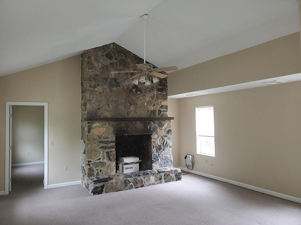 Large living room has non-functional fireplace which can be used as an entertainment center