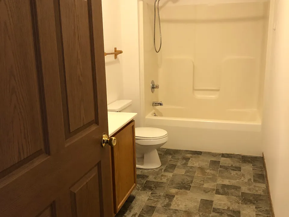 Bathroom with new flooring, and accessable off of hallway.