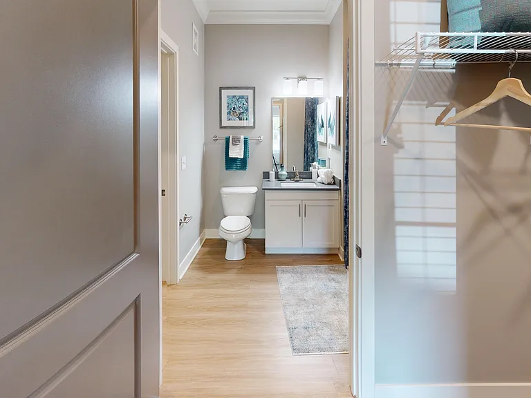 Everything in one place: This en suite bathroom features an oversized vanity, spacious shower/tub, and direct access to a walk-in closet.