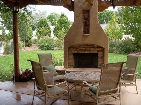 outdoor patio with woodburning fireplace