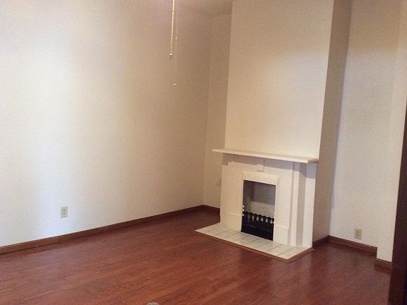 Large dining room with ceiling fan, hardwood floors and fire