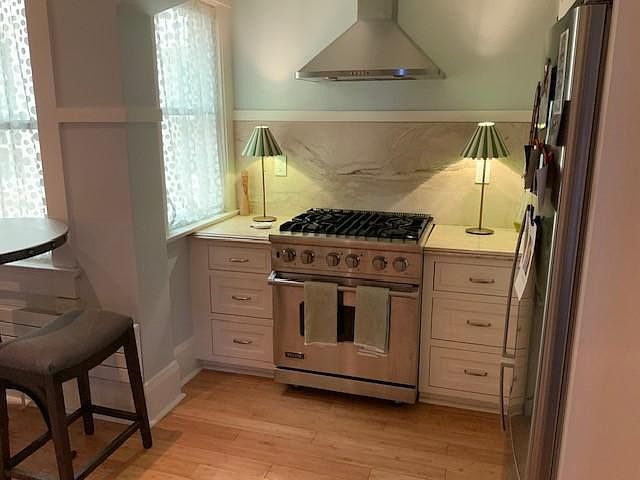 Stainless steel gas stove and range hood.