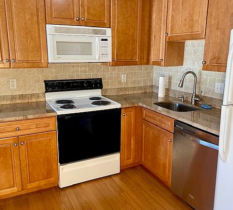 Kitchen includes electric stove, microwave, dishwasher