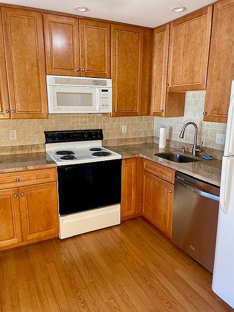 Kitchen includes electric stove, microwave, dishwasher