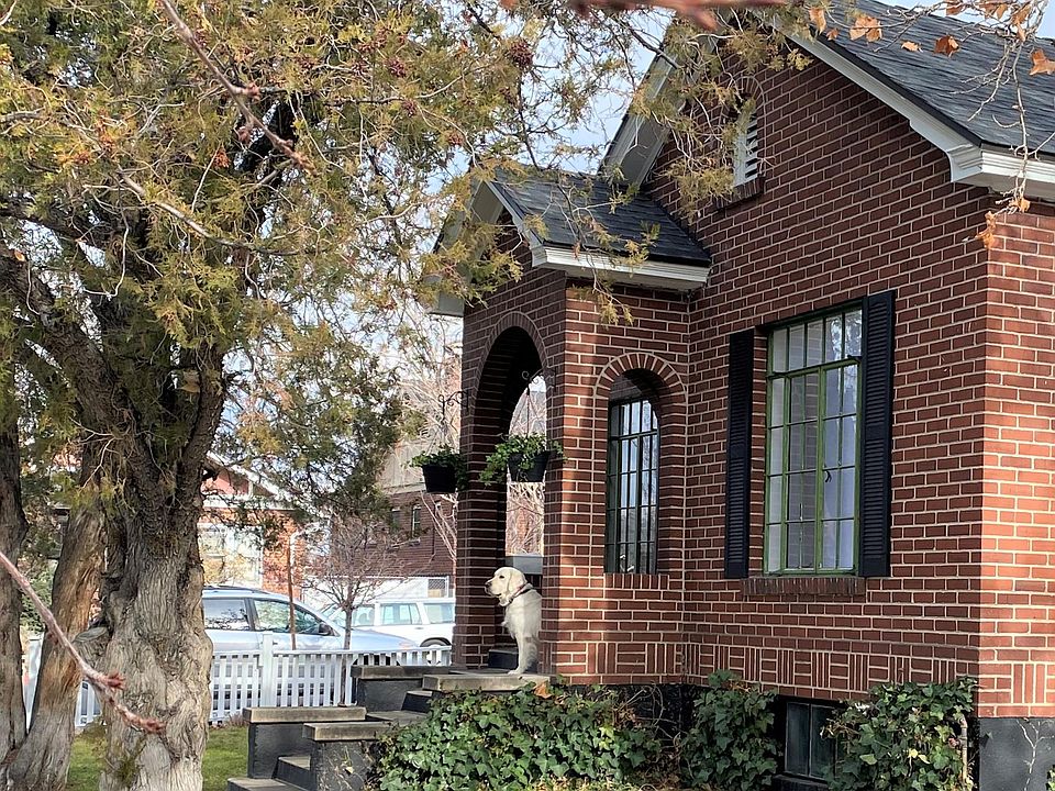 Charming brick house. Deco front door, cottage garden, and brick walkway leads to expansive deck. Dog is NOT included with the house! :)