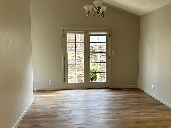 Dining room with connection ton to the kitchen. French doors open up to side yard and BBQ area.