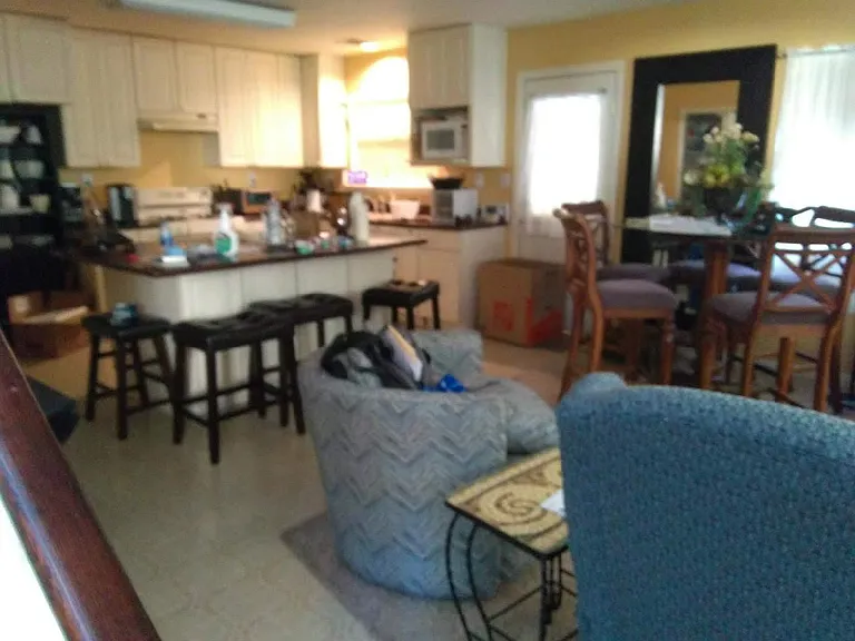 Bottom floor living room, kitchen w/island, half bath.