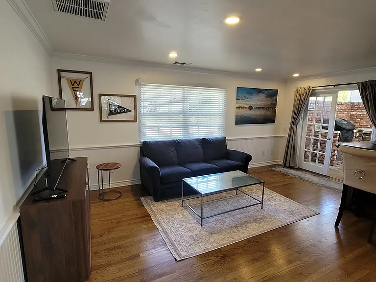 Family room, complete with bar and opens to downstairs covered patio and grilling area.