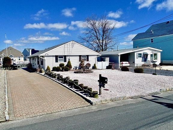Front with paved driveway