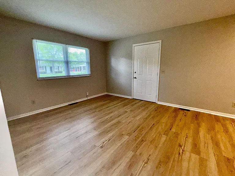 Living room area featuring fresh paint and new flooring.