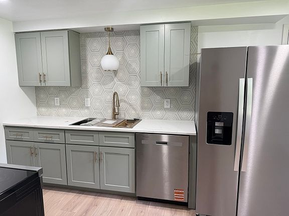 Kitchen with new dishwasher and refrigerator