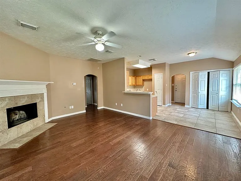 Open concept. Highlights fireplace, bar, and dining area.