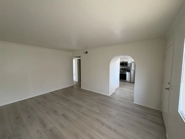 Living room looking at the archway into the kitchen