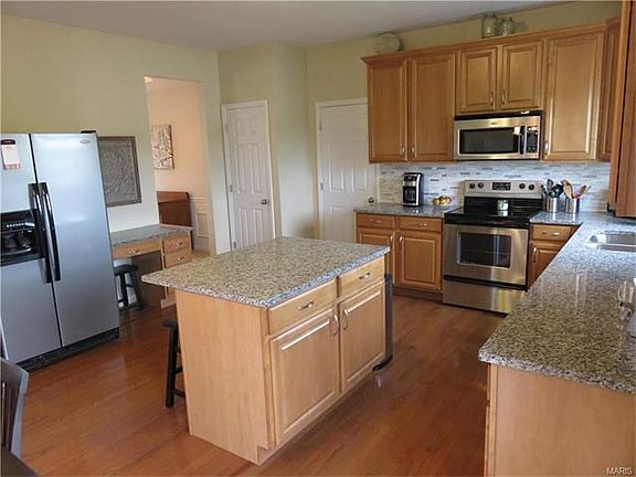 Gorgeous and neutral kitchen with planning desk and plenty of cabinets and counter space for the discriminating chef.