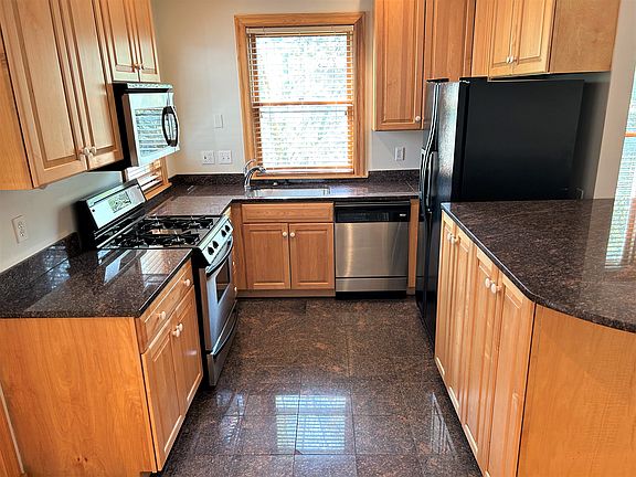 Fully equip granite kitchen. Includes garbage disposal, dishwasher, vented microwave, gas range, large fridge. Eat at island, roll out cabinet shelves, plenty of counter space!
