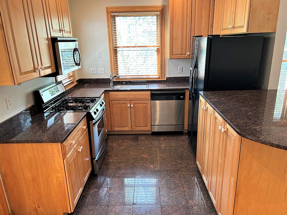 Fully equip granite kitchen. Includes garbage disposal, dishwasher, vented microwave, gas range, large fridge. Eat at island, roll out cabinet shelves, plenty of counter space!