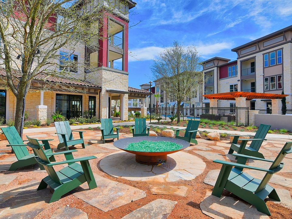 A courtyard with a fire pit and chairs