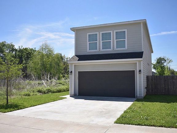 Front of house, entryway is on the left side.