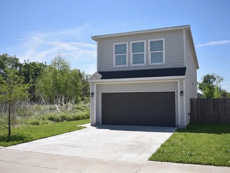 Front of house, entryway is on the left side.