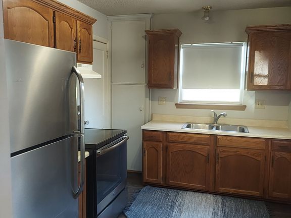 Kitchen, new flooring, and newer oven and stove .