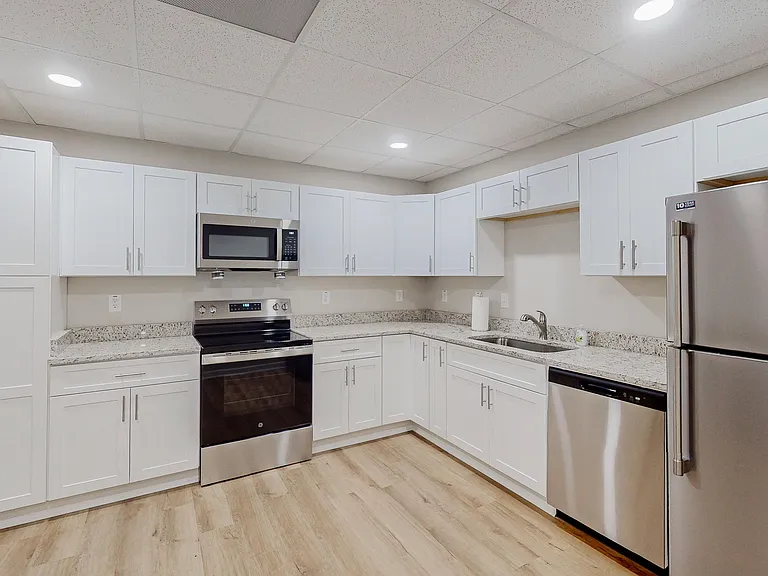Fully equipped kitchen with microwave, stove & dishwasher.