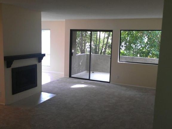 Cozy living room with fireplace and private balcony