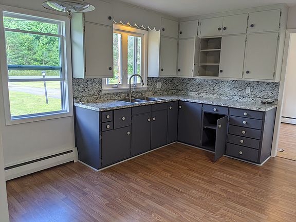 Kitchen counter, cabinets, and 2 bay sink