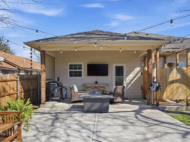Covered patio with exposed wood posts, concrete flooring, and recessed lighting