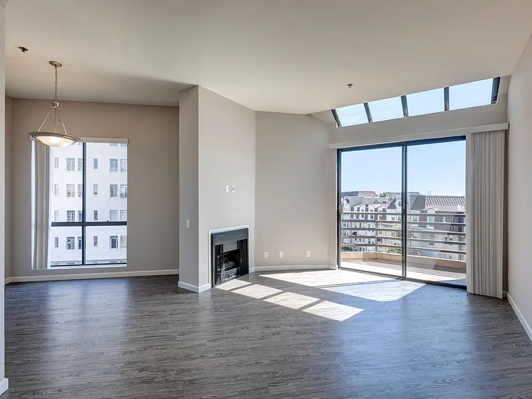 Chelsea Court One Bedroom Apartment Dining Room, Living Room with Fireplace and Sliders to Balcony