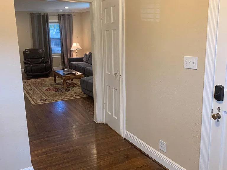 Front hallway, half bath to the right (closed door), ahead is the living room.