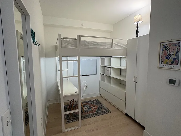 Den area repurposed as an office and guest room (with a memory foam double bed)