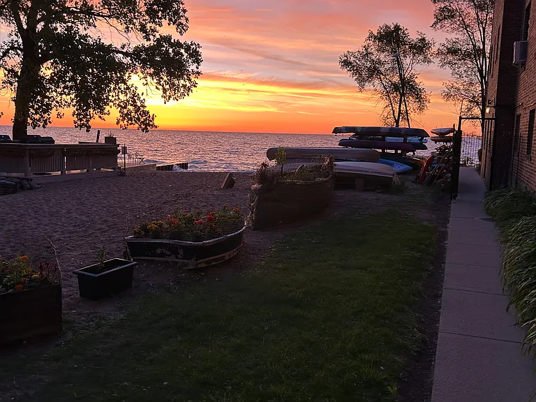 View of sunrise from side of building showing common lake entry area.