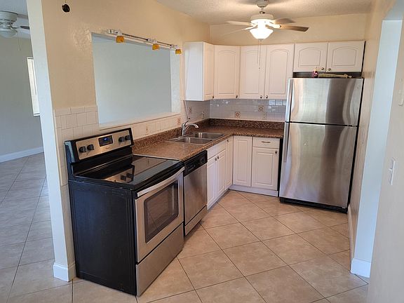 Newly Renovated Kitchen (with Stainless Steel Appliances and Open Layout View of Living Room)