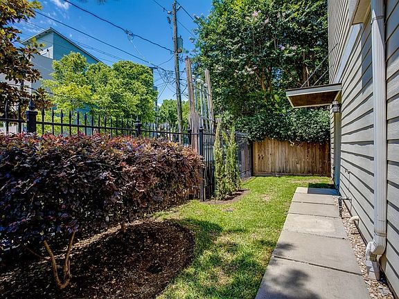 This corner unit has a private gate access, iron fenced yard, and covered front stoop.  Great property inside and out!