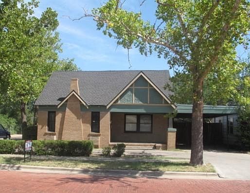 Front exterior and 2 car carport