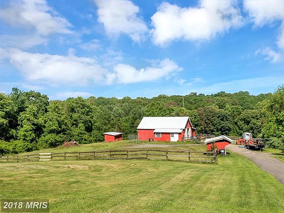 Large barn with multiple stalls and storage sheds!