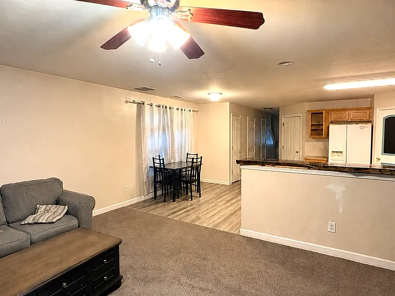 Living room connects to open-concept kitchen and dining area