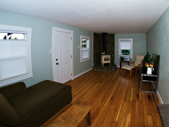 The gas stove in the living room is cozy and heats the whole house!