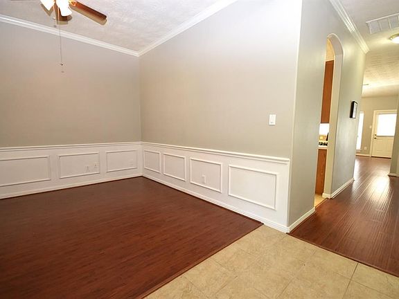 As you open the door to your new home, welcoming family and friends, there is warm neuatral colored ceramic tile flooring separating the formal dining and study.